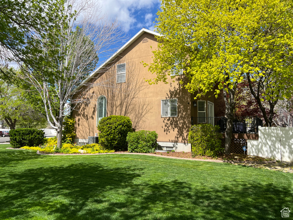 View of front of home with a front yard and stucco siding