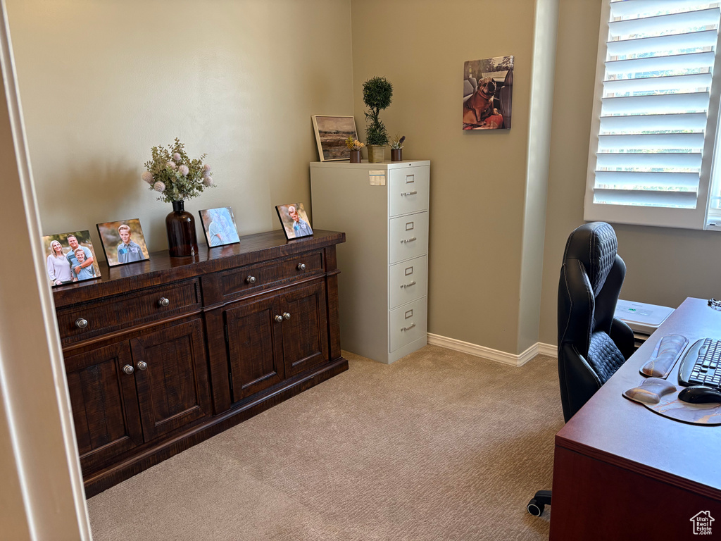 Home office featuring light carpet and baseboards