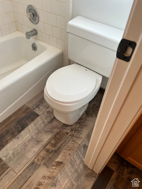 Full bath featuring wood finished floors and toilet