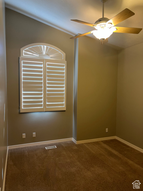 Unfurnished room with carpet flooring, baseboards, crown molding, and a ceiling fan