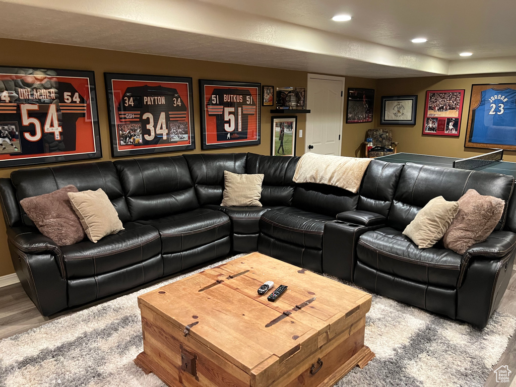 Living area featuring wood finished floors and recessed lighting