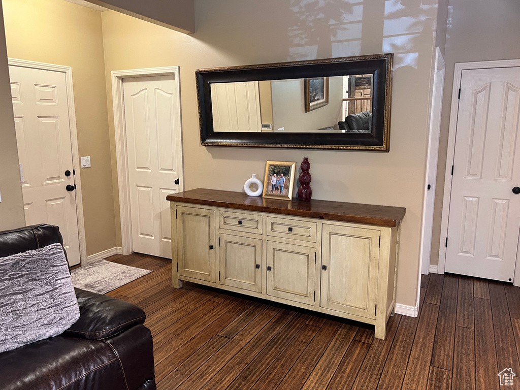 Sitting room featuring dark wood-type flooring and baseboards