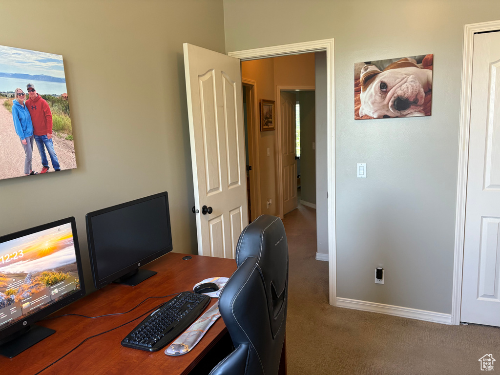 Home office with carpet floors and baseboards