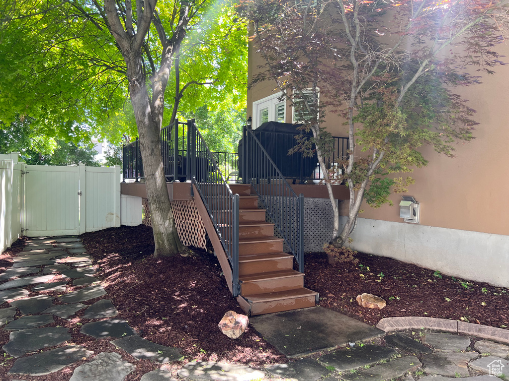 View of yard featuring stairs, a gate, and a deck