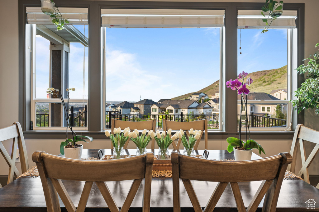 Dining space featuring plenty of natural light and a residential view