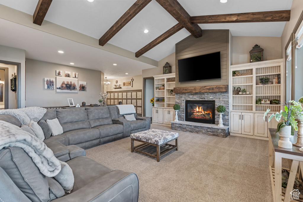 Carpeted living area featuring recessed lighting and a stone fireplace