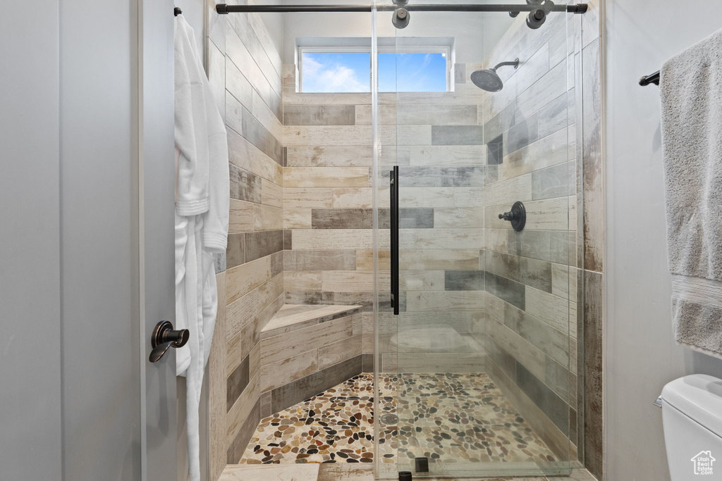 Bathroom featuring a stall shower and toilet