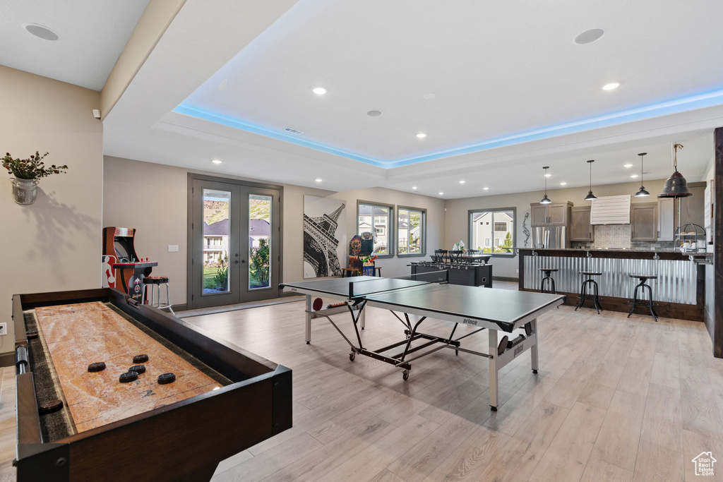 Rec room with french doors, recessed lighting, light wood-type flooring, and a raised ceiling