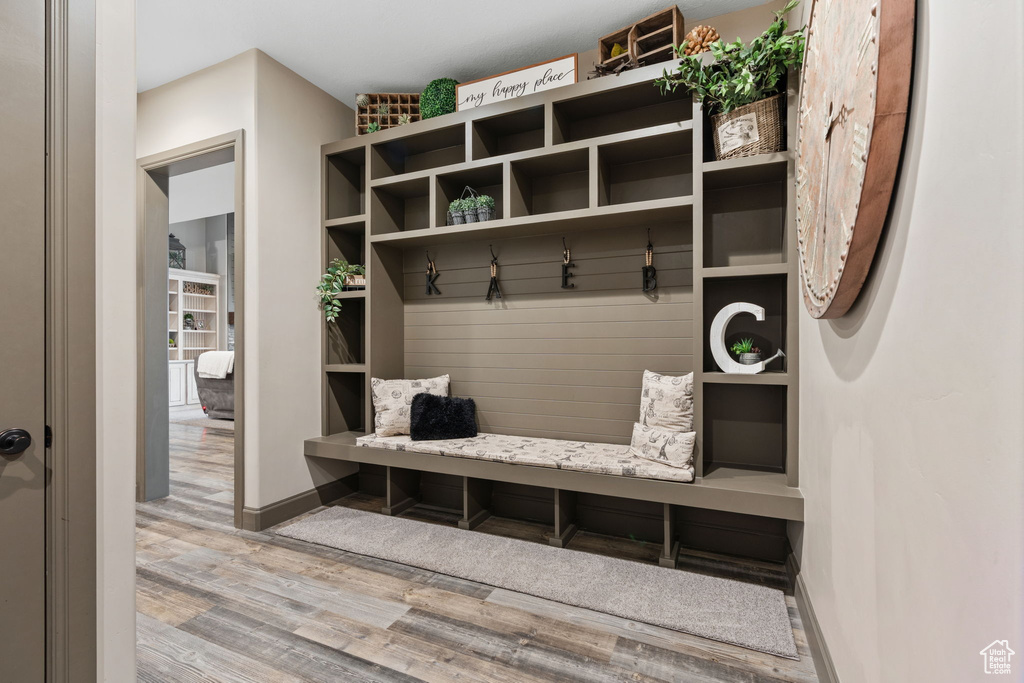 Mudroom featuring wood finished floors and baseboards