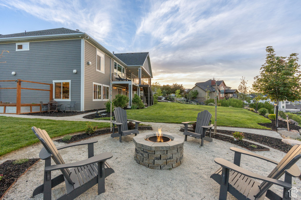 View of patio with an outdoor fire pit