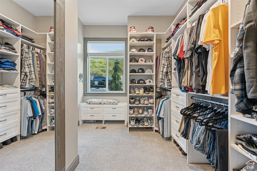 Walk in closet with carpet flooring