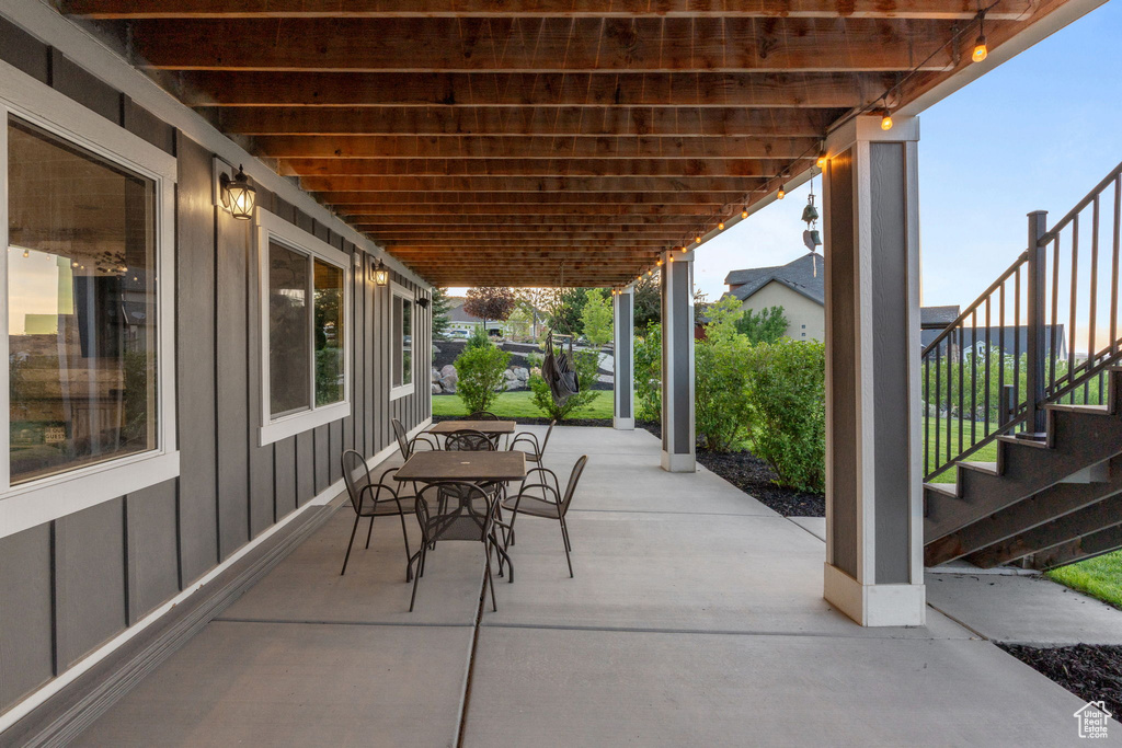 View of patio featuring stairway and outdoor dining area