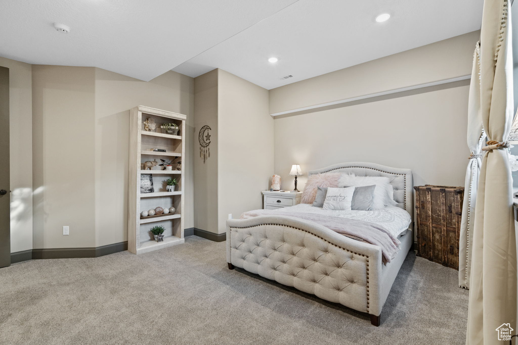 Carpeted bedroom with baseboards and recessed lighting
