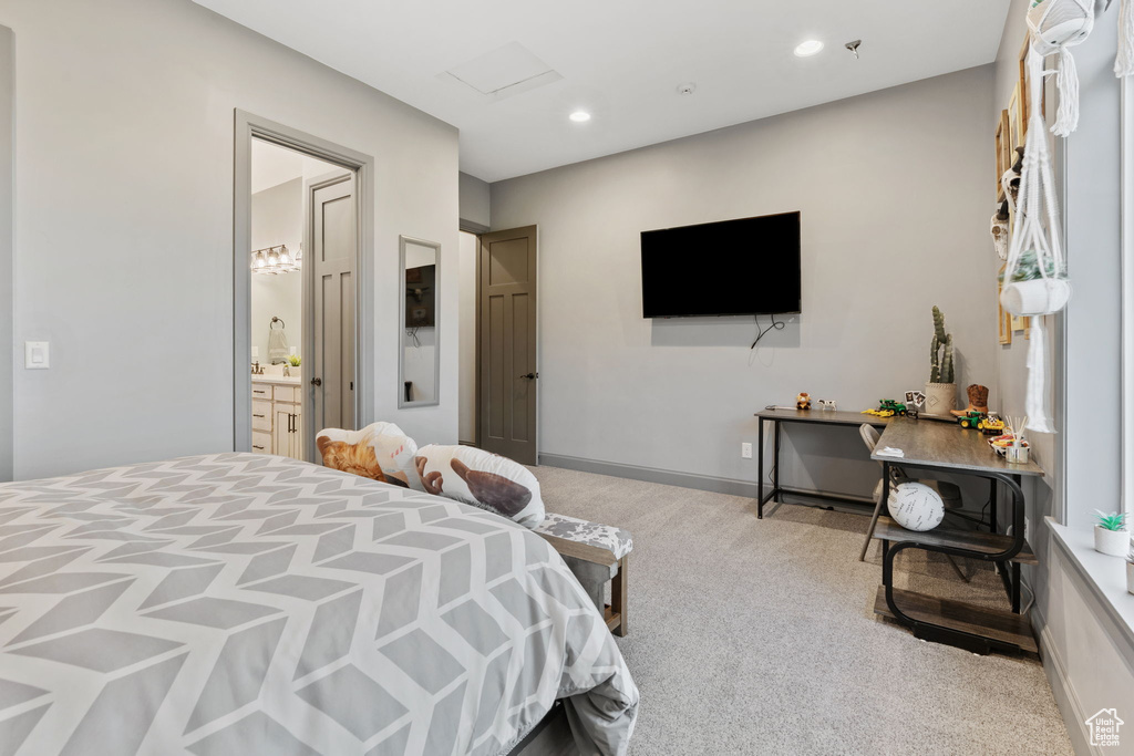 Carpeted bedroom with recessed lighting and ensuite bath