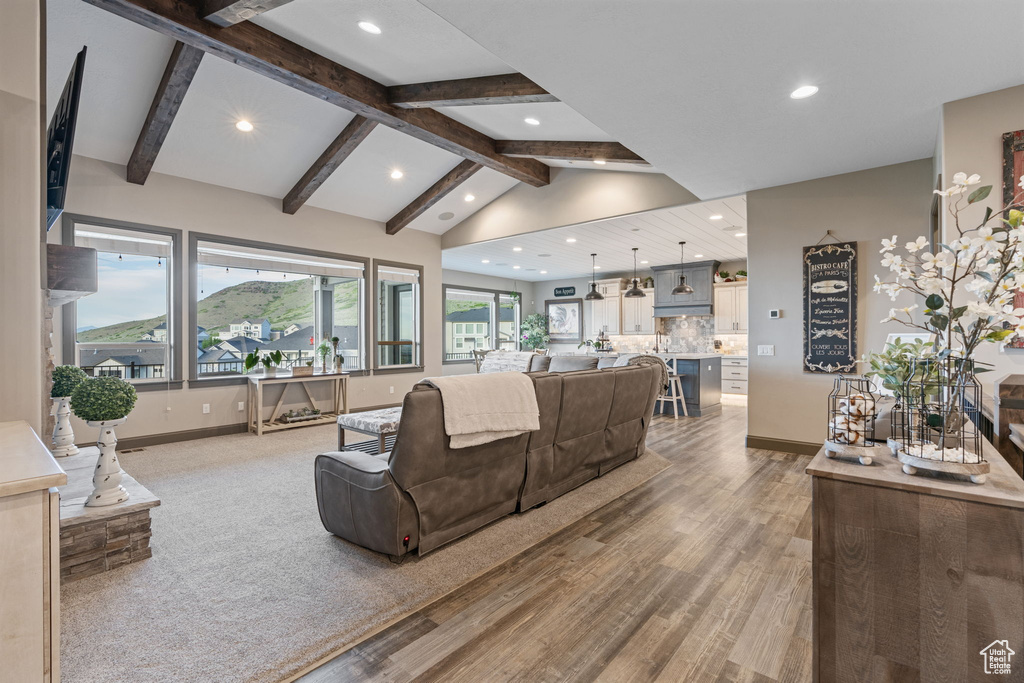 Living room with recessed lighting, light wood-style flooring, and baseboards