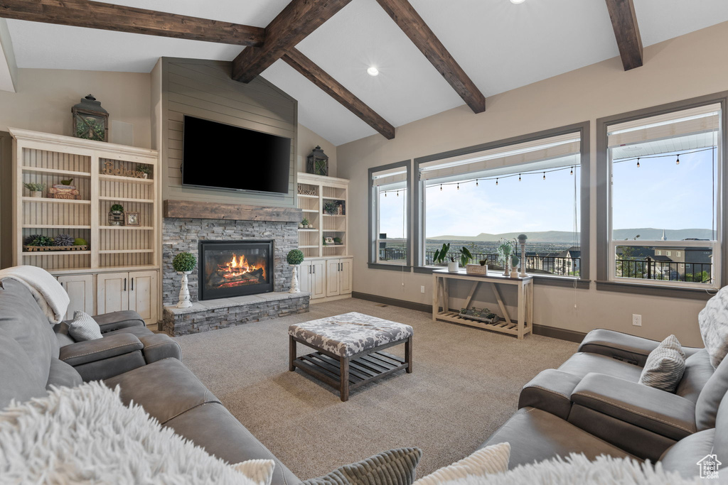 Carpeted living room featuring a stone fireplace, baseboards, and recessed lighting