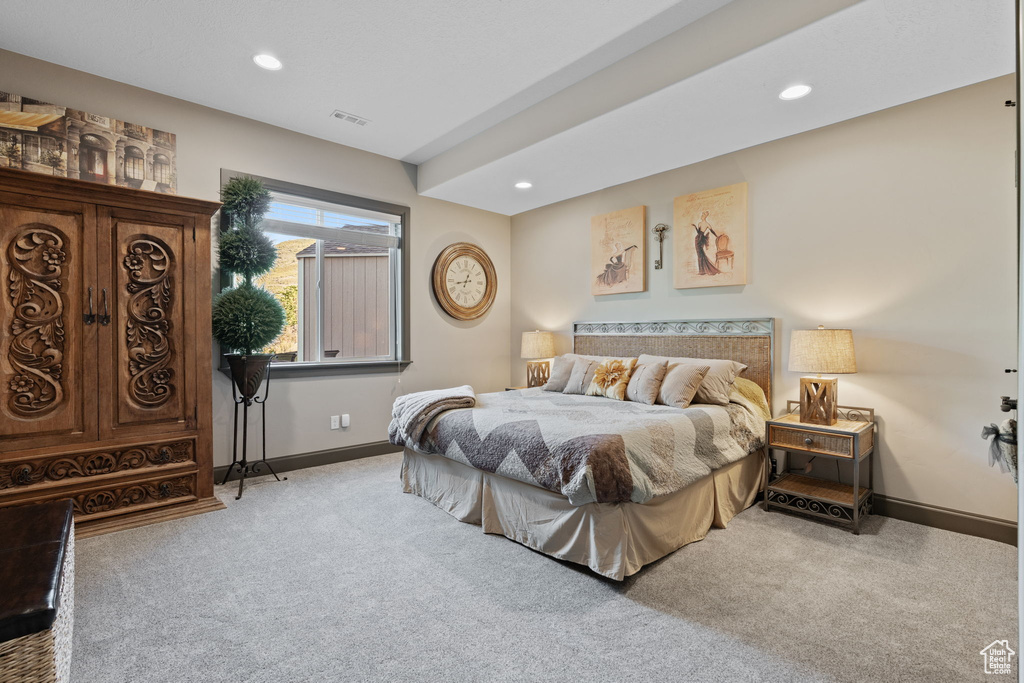 Carpeted bedroom with baseboards and recessed lighting