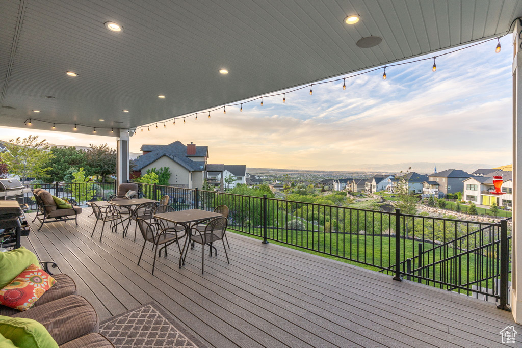 Wooden terrace featuring outdoor dining space and a residential view