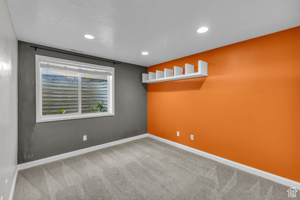 Carpeted spare room featuring baseboards and recessed lighting