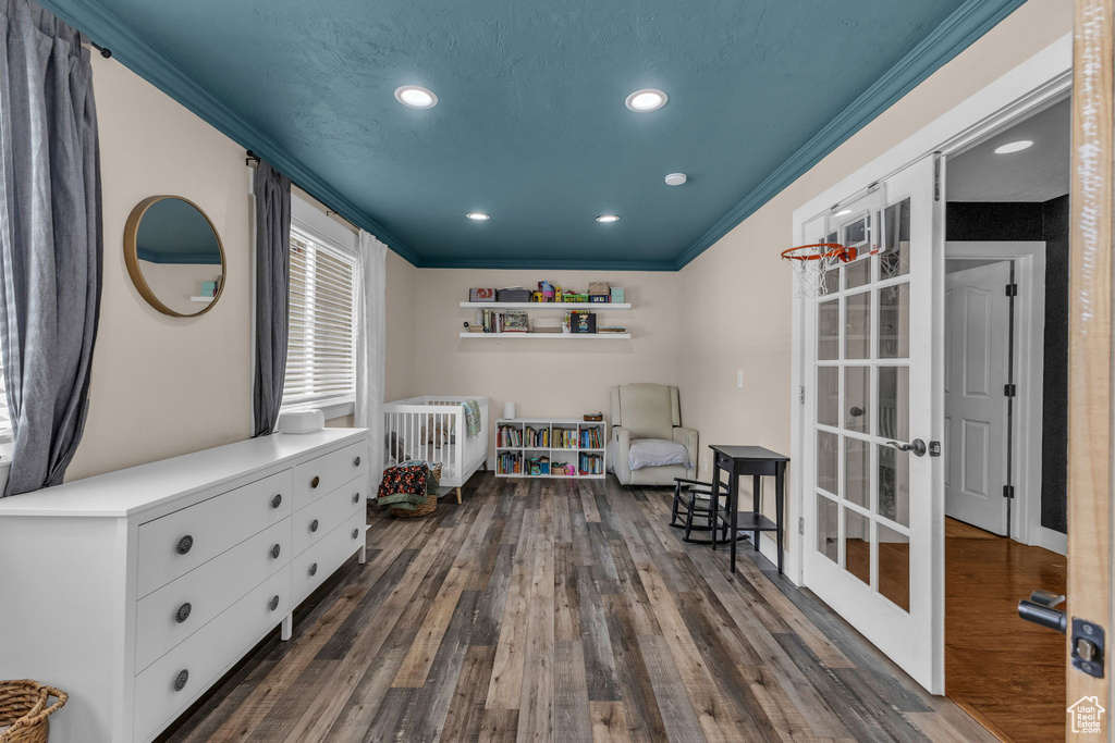 Bedroom featuring crown molding, dark wood-type flooring, french doors, and recessed lighting