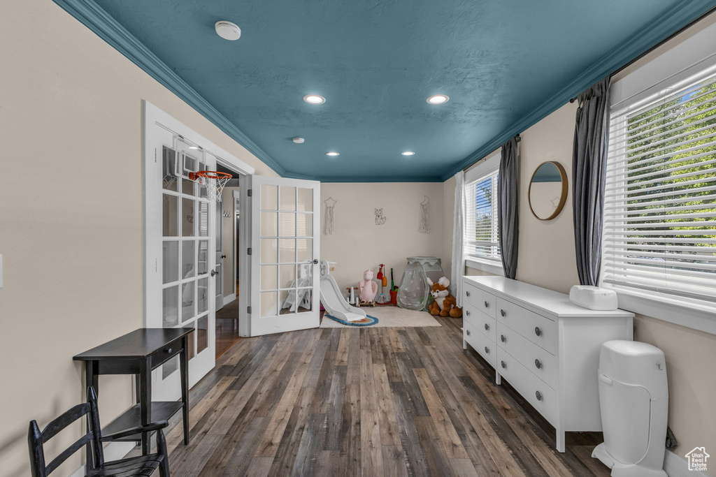 Playroom featuring recessed lighting, healthy amount of natural light, wood finished floors, ornamental molding, and french doors
