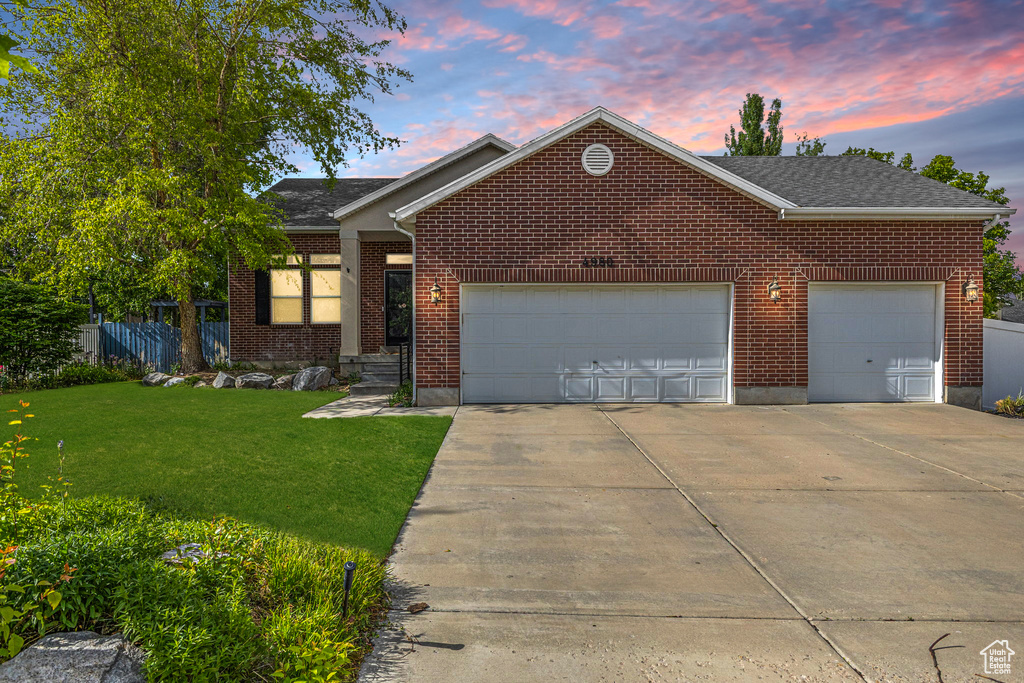 Single story home featuring concrete driveway, a garage, and brick siding