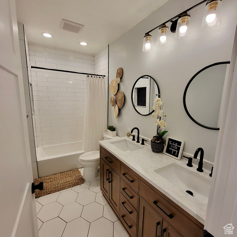 Full bathroom featuring double vanity, toilet, shower / tub combo with curtain, tile patterned flooring, and recessed lighting