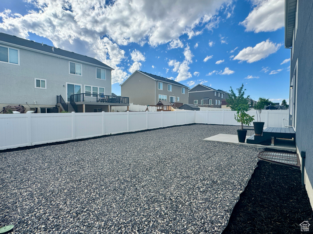 Fenced backyard with a residential view and a patio area