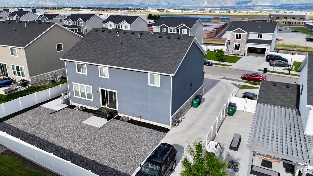 Aerial perspective of suburban area with a mountainous background