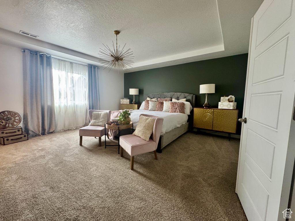 Carpeted bedroom with a textured ceiling