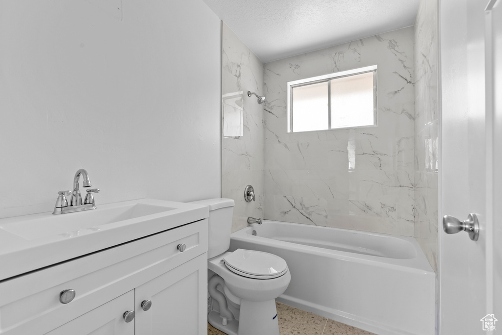 Full bathroom featuring toilet,  shower combination, and vanity