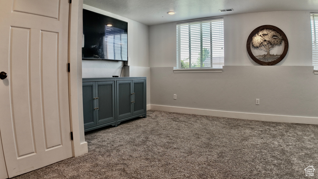 Unfurnished bedroom featuring carpet floors and baseboards
