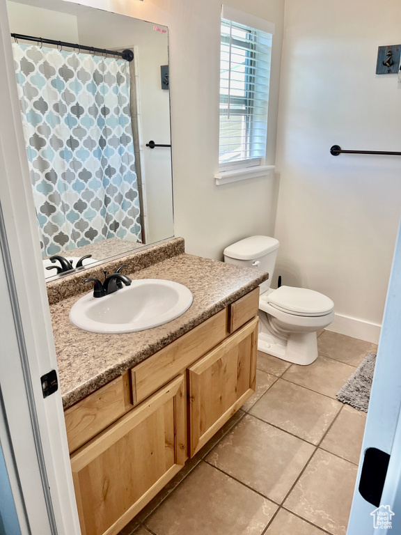 Bathroom featuring vanity, toilet, and tile patterned floors