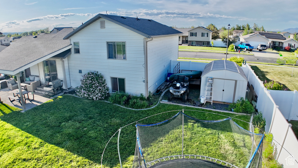 Back of house featuring outdoor lounge area, a patio area, and a residential view