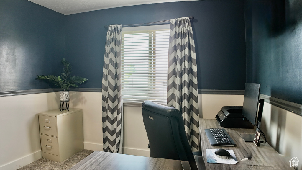 Carpeted office space featuring baseboards