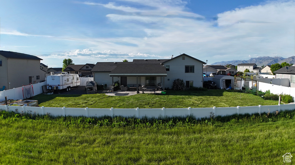 Back of property with a residential view, a patio area, outdoor lounge area, and a mountain view