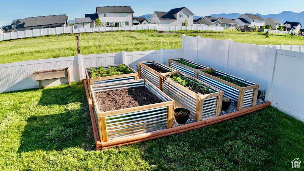 Exterior view of a residential view, a garden, and a mountainous background