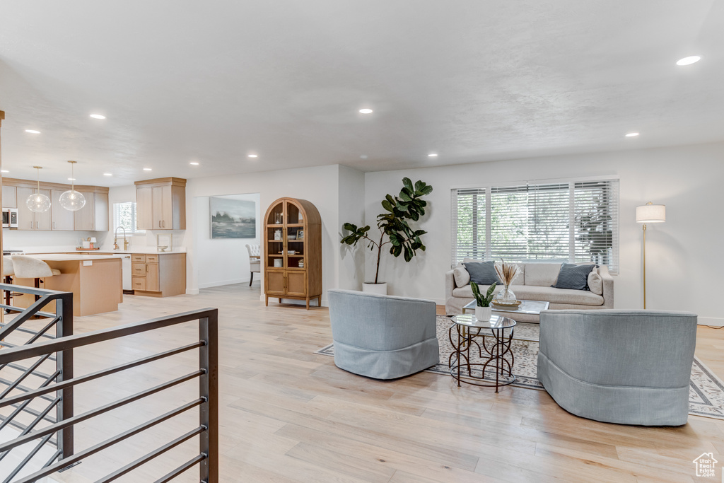 Living area with recessed lighting, light wood-type flooring, and baseboards
