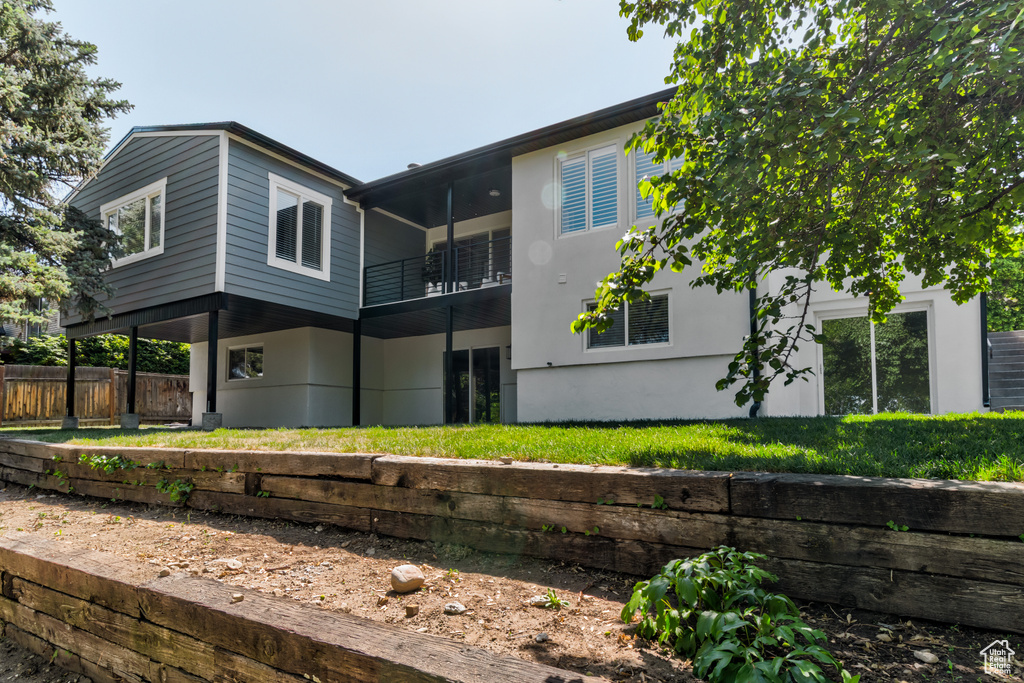 Back of house with a balcony