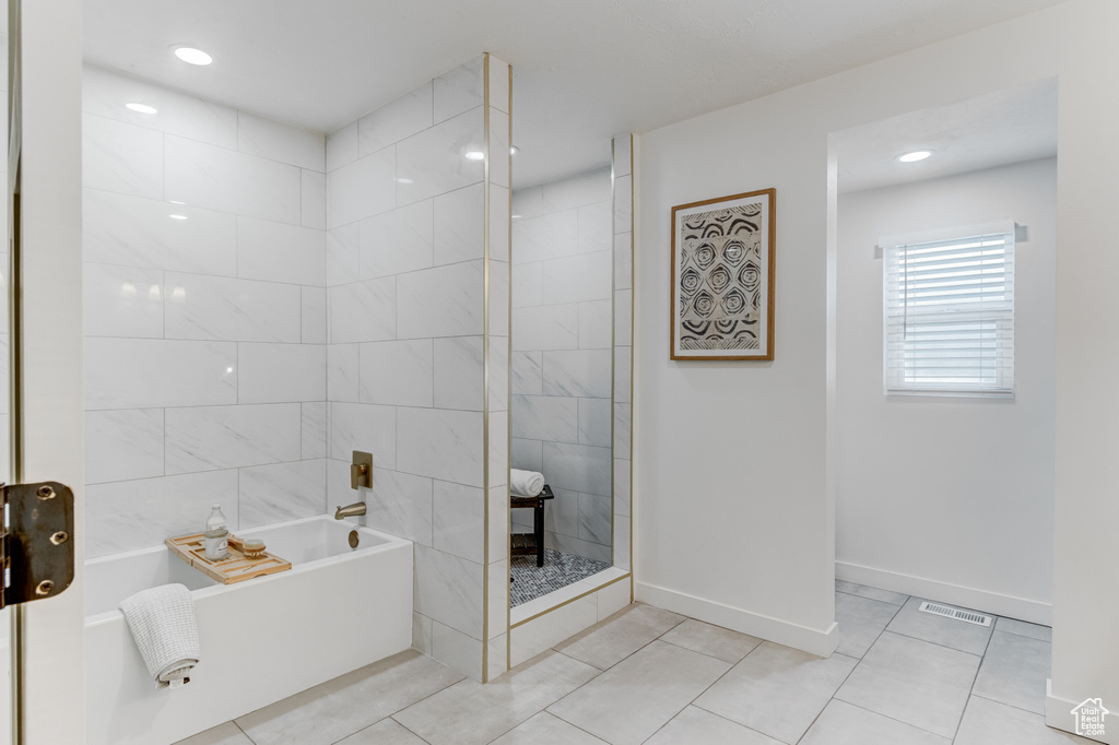 Full bathroom featuring a tub, tile patterned flooring, baseboards, a shower, and recessed lighting