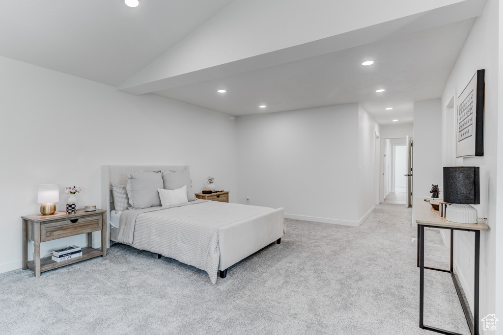 Bedroom with recessed lighting, carpet flooring, baseboards, and vaulted ceiling