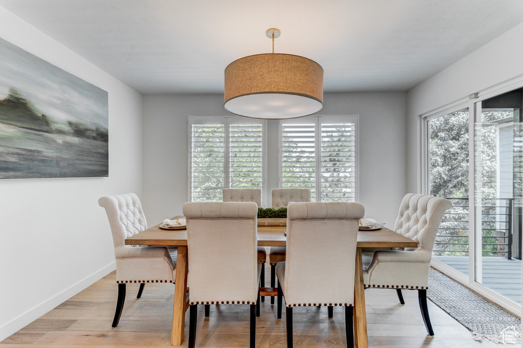 Dining space featuring light wood-type flooring and baseboards