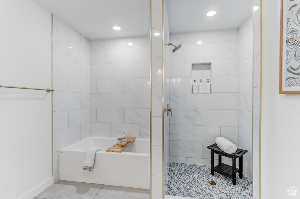 Bathroom with a tile shower, a bath, tile patterned floors, and recessed lighting