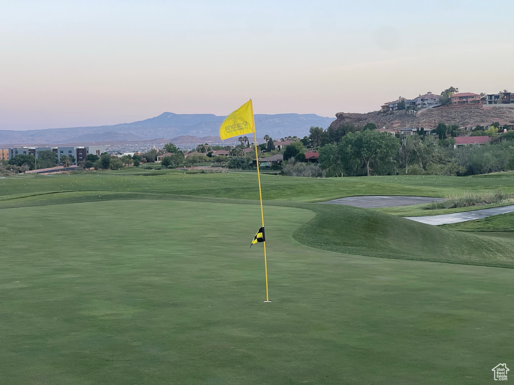 View of community featuring golf course view, a mountain view, and a putting area