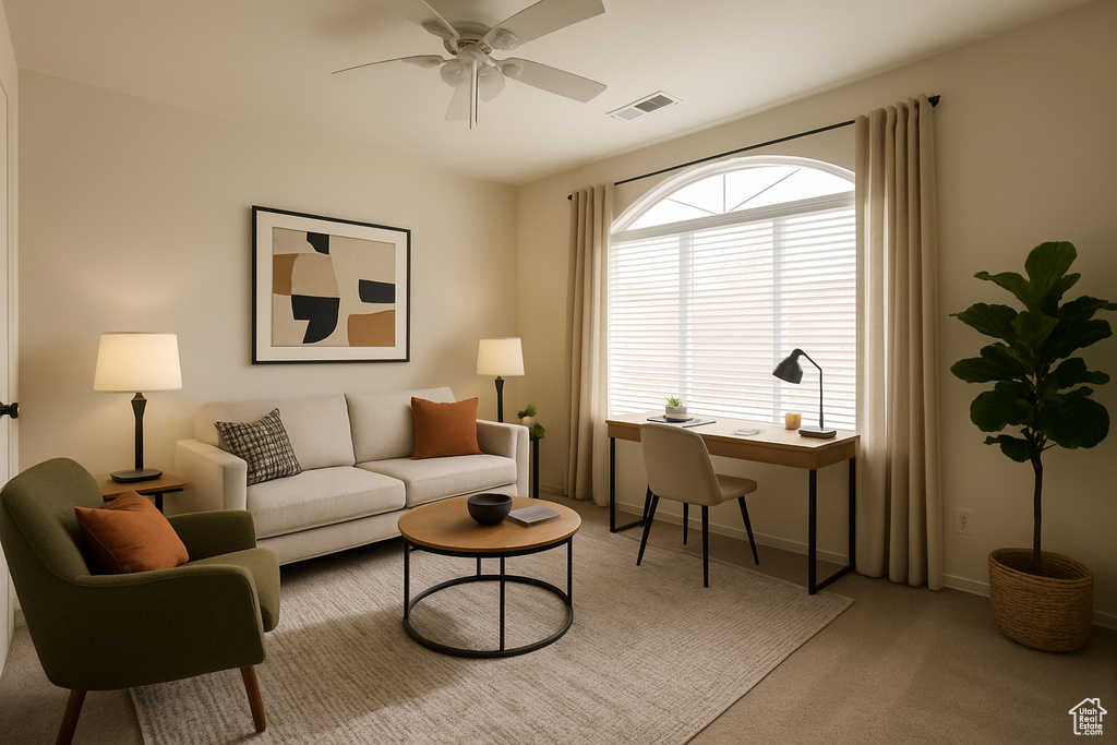Living area with an office area, carpet flooring, ceiling fan, and baseboards