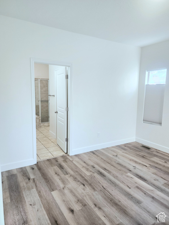 Empty room featuring wood finished floors and baseboards