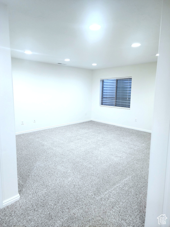Empty room with carpet, baseboards, and recessed lighting