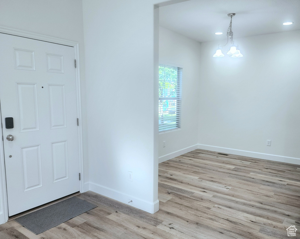Foyer entrance with light wood-type flooring, baseboards, and recessed lighting