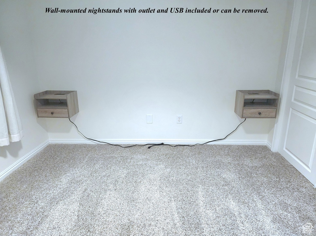 Carpeted empty room with baseboards