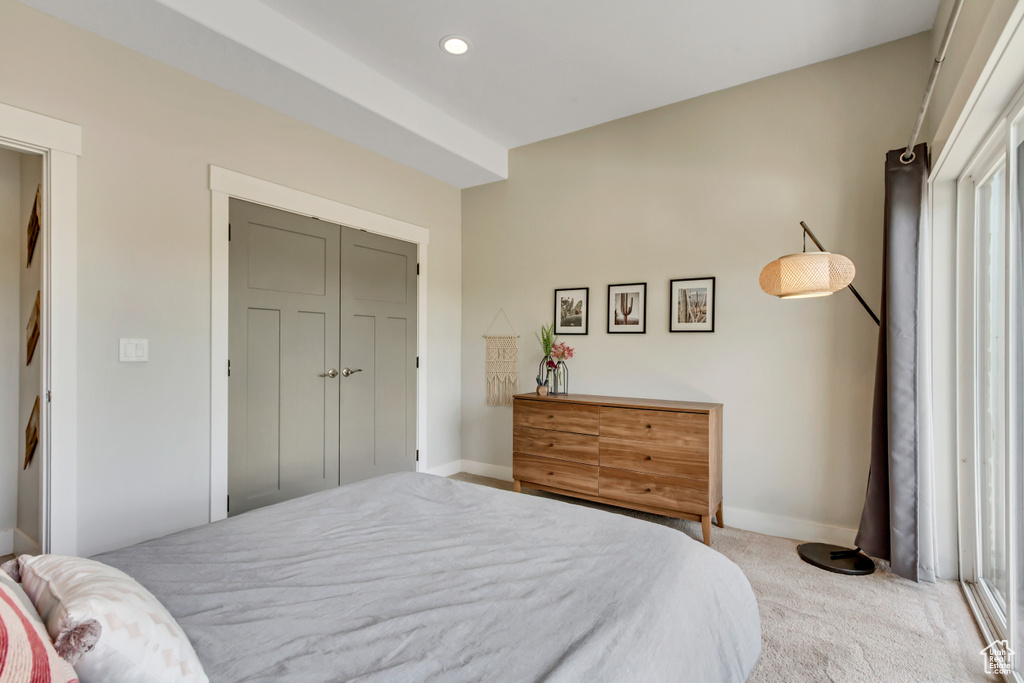 Carpeted bedroom with baseboards and recessed lighting